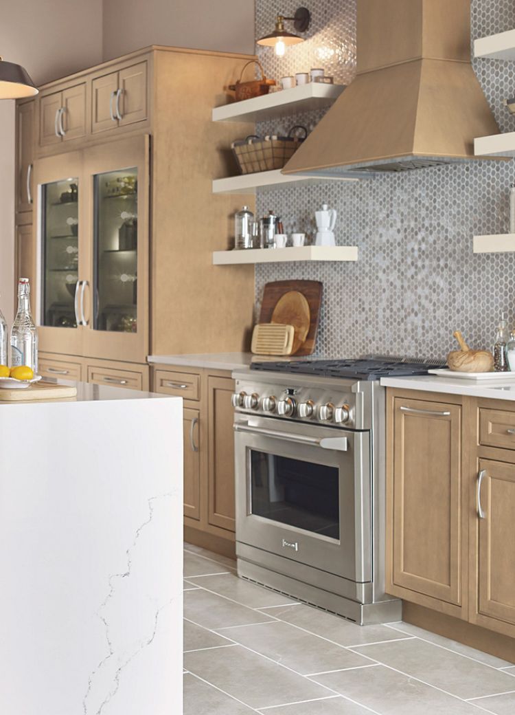 patterned tile kitchen backsplash in a moderrn kitchen with wood cabinets