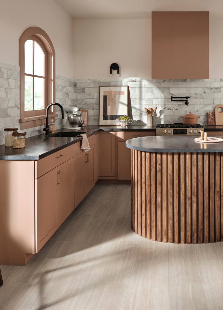 black countertops in a kitchen with terracotta cabinets