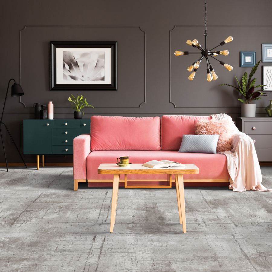 carpet in living room, pink couch, wood table, green cabinet in back